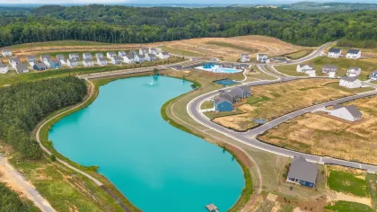 Welcome sign for Calhoun Historic Downtown, featuring stone design and green background under blue sky.
